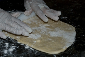 Flatten dough with rolling pin
